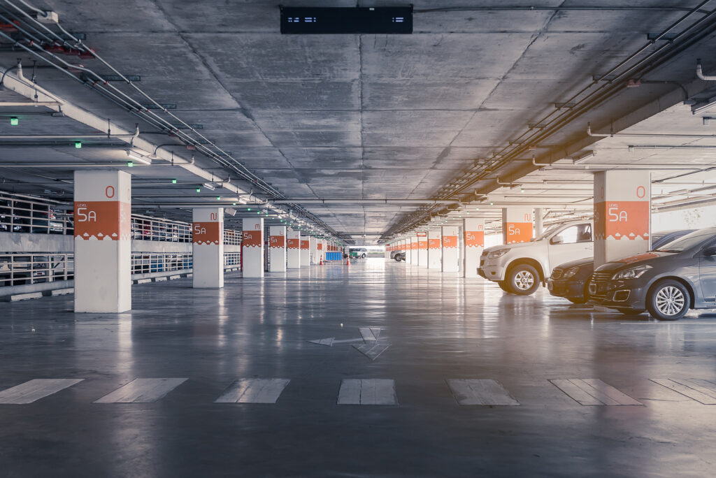 Interior,Of,Parking,Garage,With,Car,And,Vacant,Parking,Lot interior of parking garage with car and vacant parking lot in parking building, vintage style process